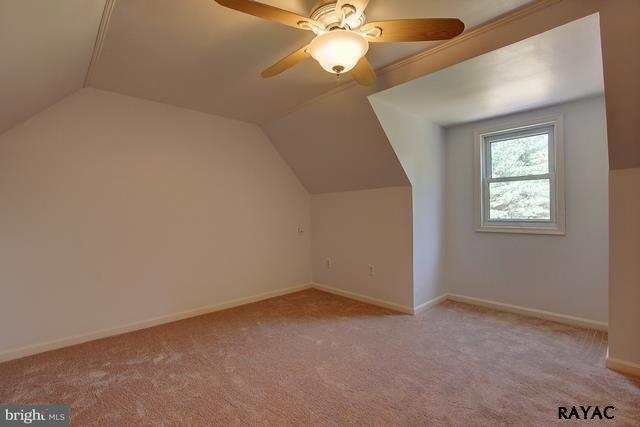 7952 Hickory Road Stewartstown, PA 17363 - Photo 8 of 14 an empty room with a chandelier fan and a fireplace