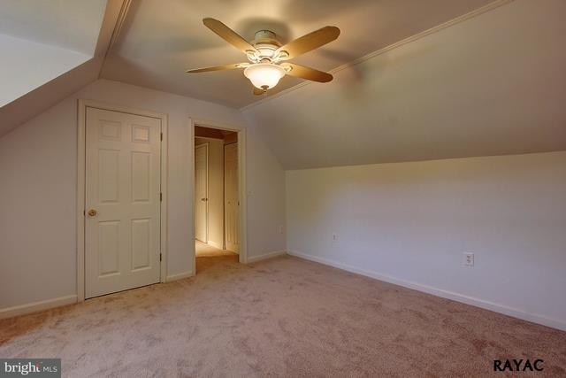 7952 Hickory Road Stewartstown, PA 17363 - Photo 9 of 14 an empty room with a chandelier fan and windows