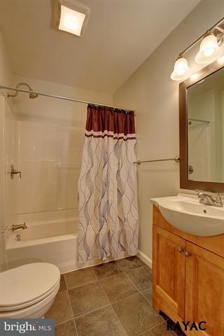 7952 Hickory Road Stewartstown, PA 17363 - Photo 10 of 14 a bathroom with a granite countertop sink toilet and shower