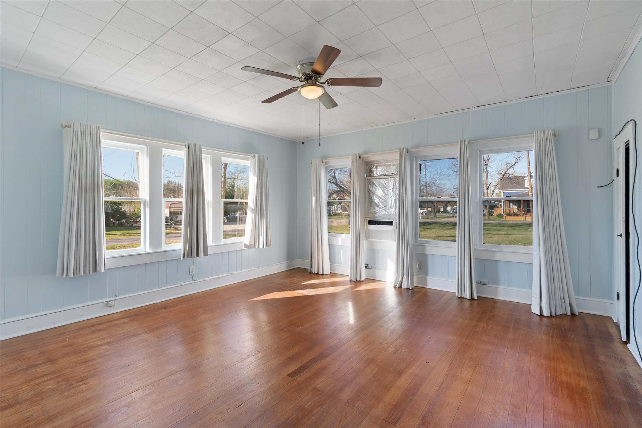 408 South Gabriel Street Granger, TX 76530 - Photo 15 of 29 a view of an empty room with a window and wooden floor