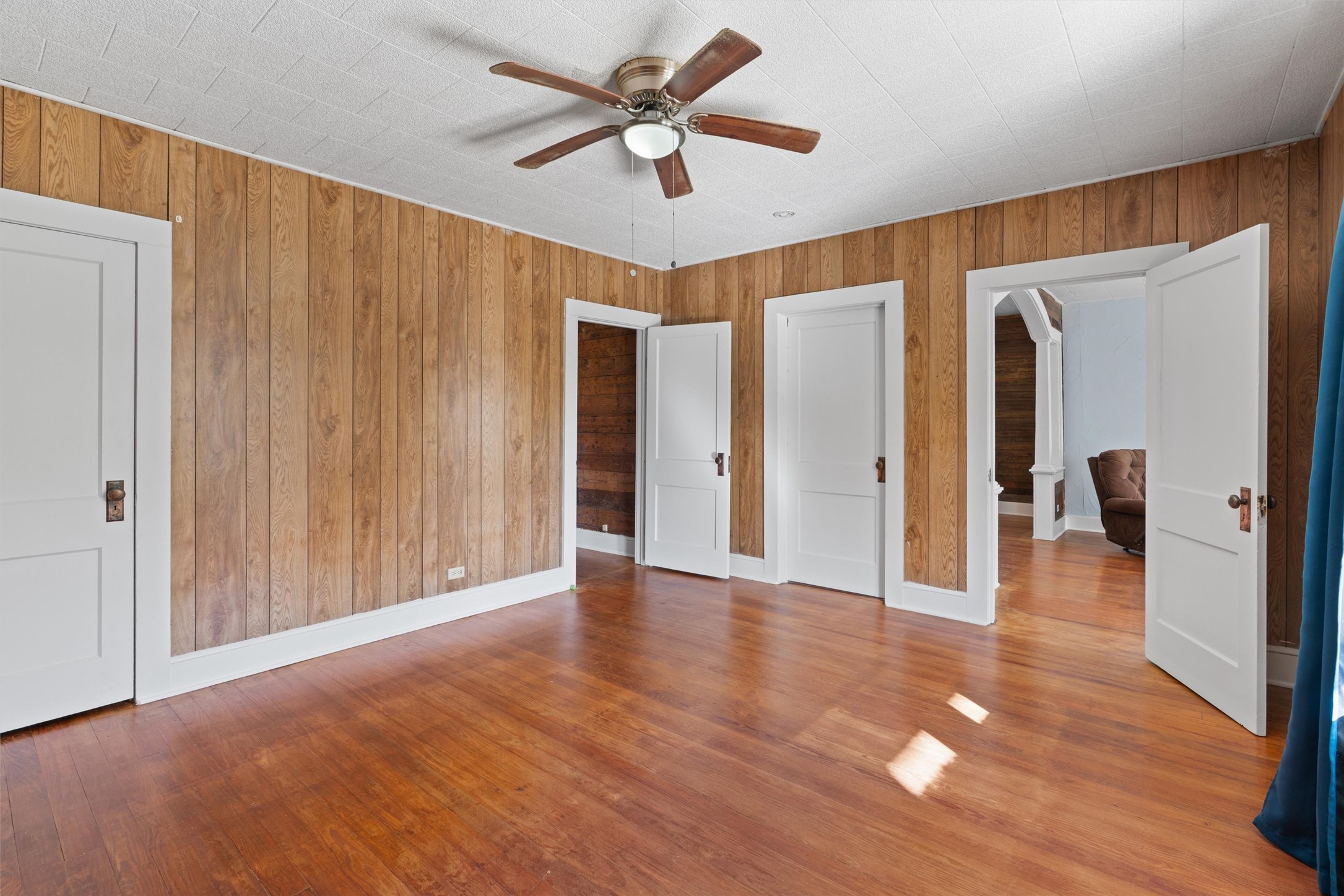 408 South Gabriel Street Granger, TX 76530 - Photo 21 of 29 a view of a livingroom with a ceiling fan wooden floor and a ceiling fan