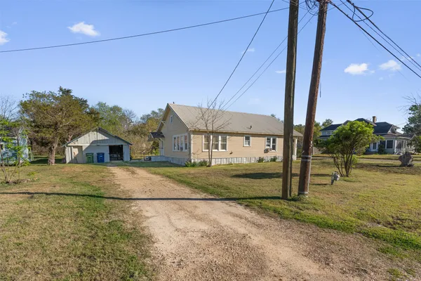 a swimming pool with outdoor seating and yard