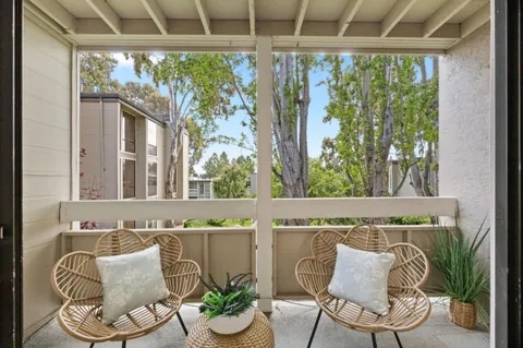 a view of balcony with furniture and garden