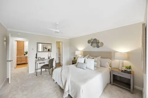 a bedroom with a bed and a chair