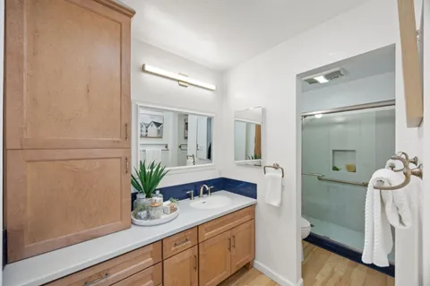 a bathroom with a shower sink and mirror
