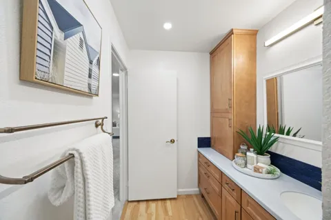 a bathroom with a granite countertop sink a mirror and a shower