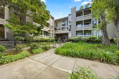 a front view of a building with a garden