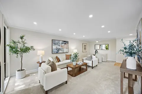 a living room with furniture potted plant and a chandelier