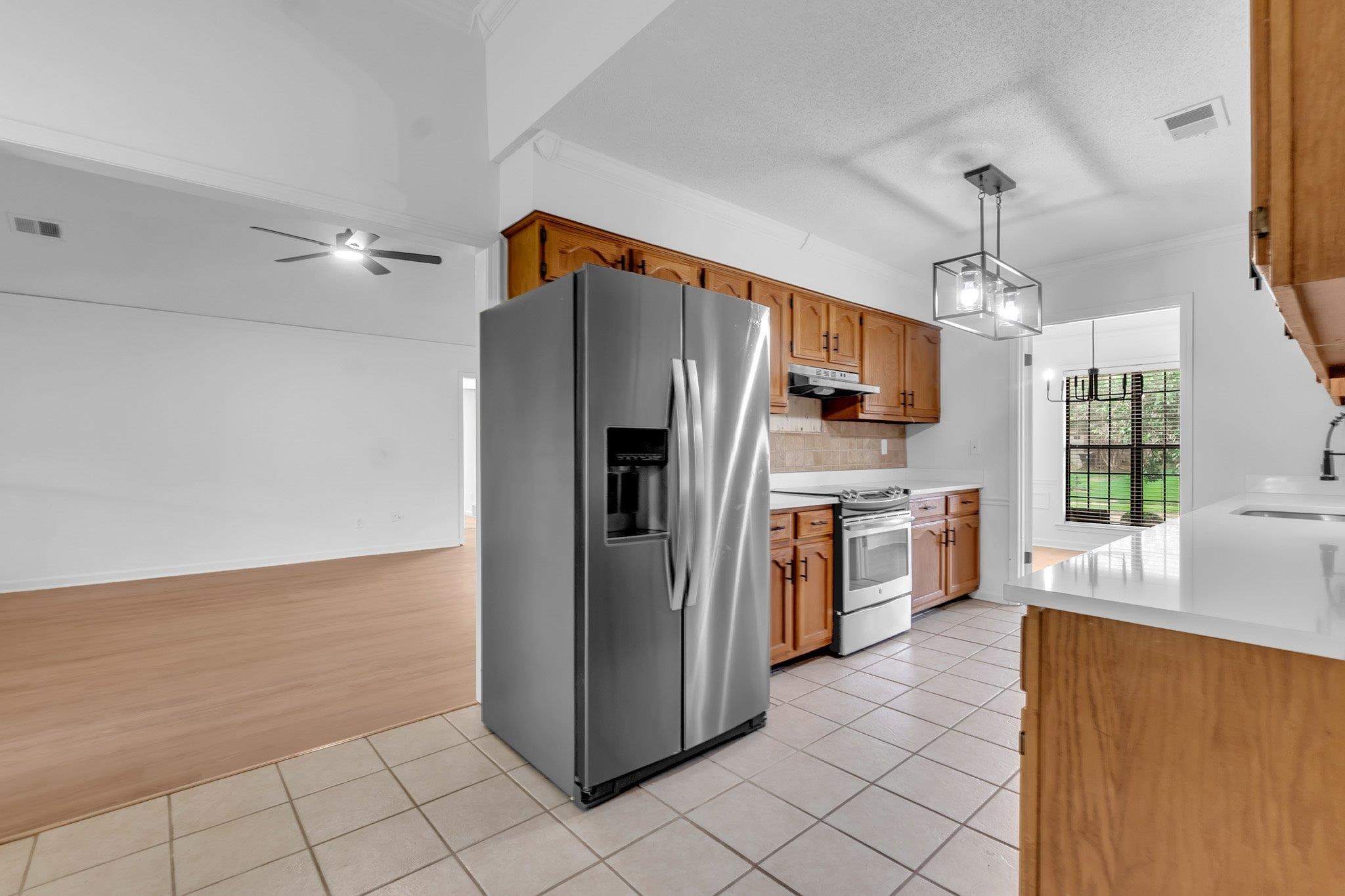 6613 Stephan Ridge Drive Bartlett, TN 38135 - Photo 11 of 24 Kitchen featuring wood cabinetry, white countertops, stainless steel appliances, and tile flooring