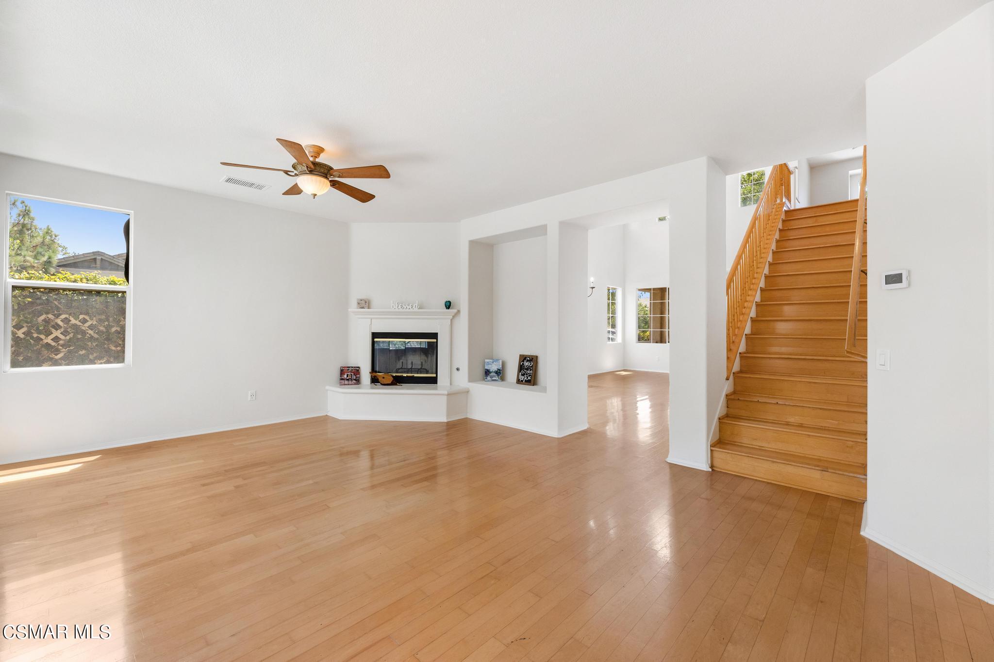 2442 Parade Avenue Simi Valley, CA 93063 - Photo 15 of 76 a view of a livingroom with wooden floor and a ceiling fan