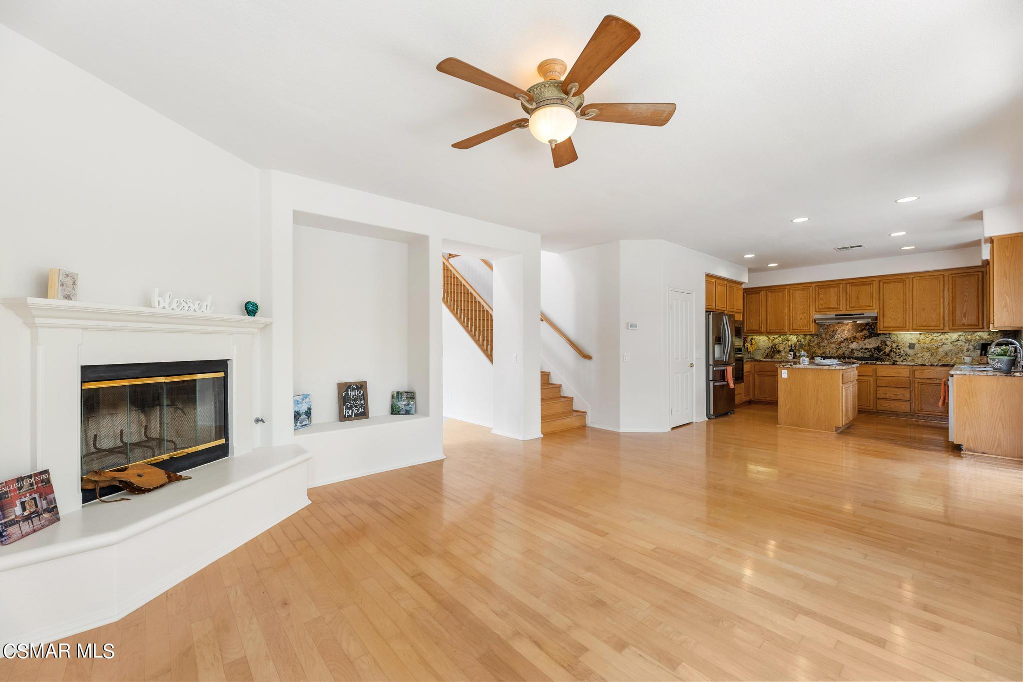 2442 Parade Avenue Simi Valley, CA 93063 - Photo 18 of 76 a view of a livingroom with a ceiling fan a fireplace and a window
