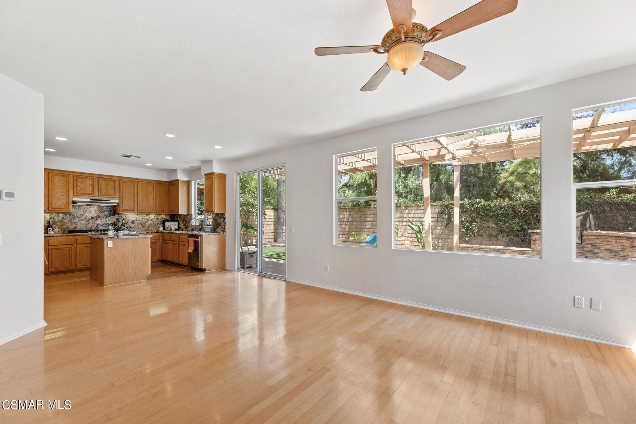 2442 Parade Avenue Simi Valley, CA 93063 - Photo 20 of 76 a view of a living room kitchen with furniture and a ceiling fan