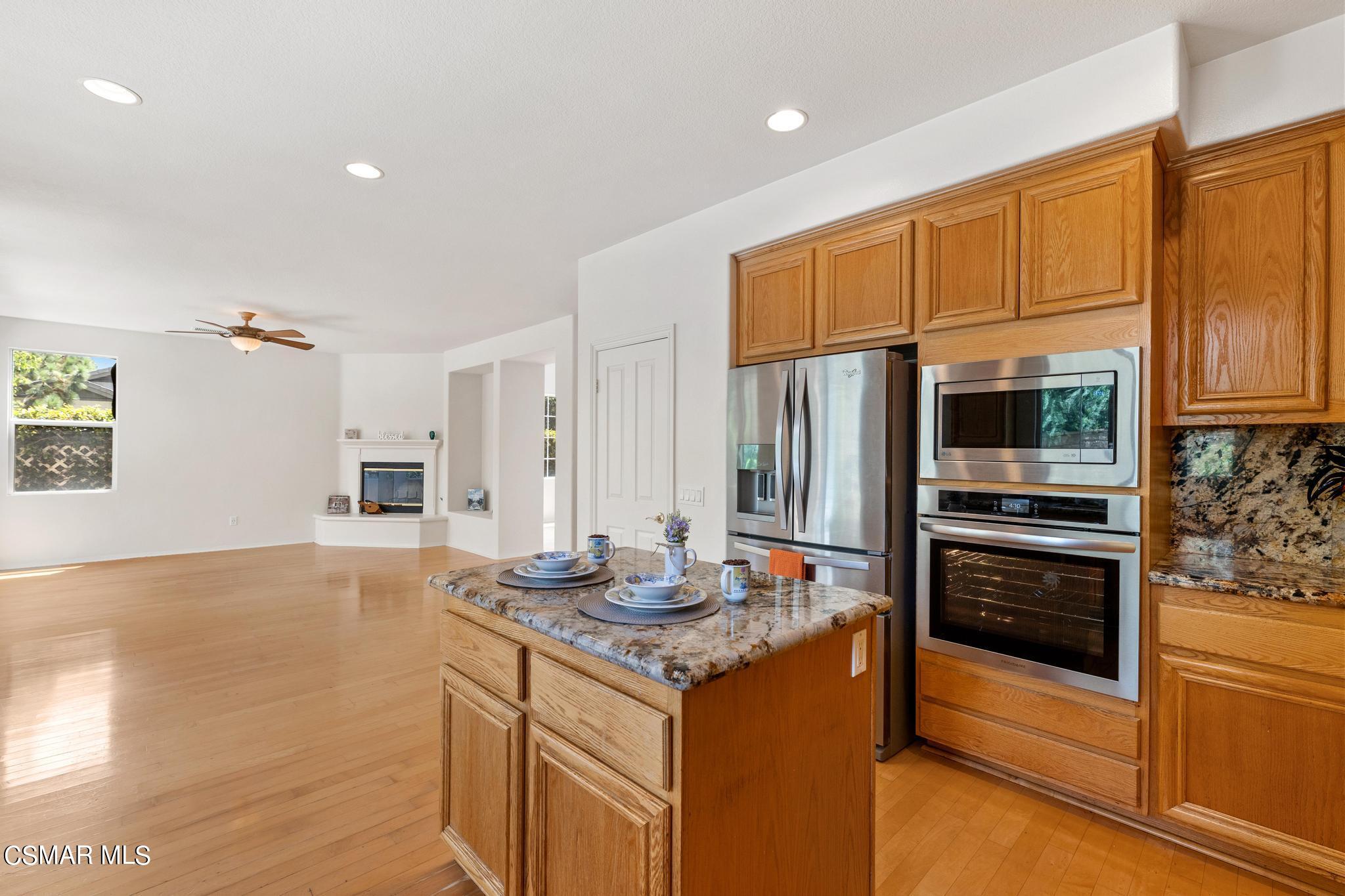 2442 Parade Avenue Simi Valley, CA 93063 - Photo 23 of 76 a kitchen with stainless steel appliances granite countertop a stove a refrigerator and a microwave