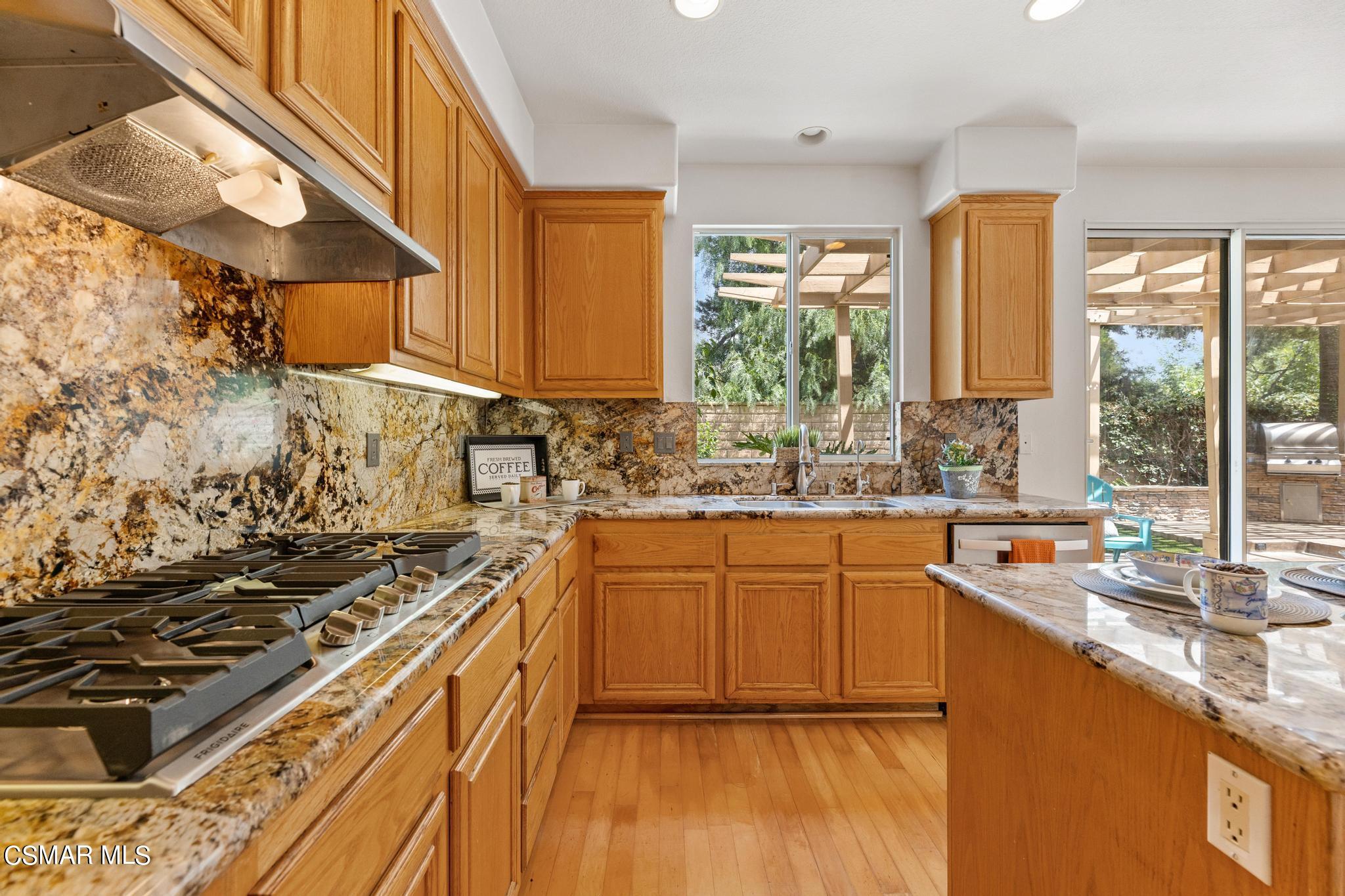 2442 Parade Avenue Simi Valley, CA 93063 - Photo 24 of 76 a kitchen with stainless steel appliances granite countertop a sink stove and cabinets