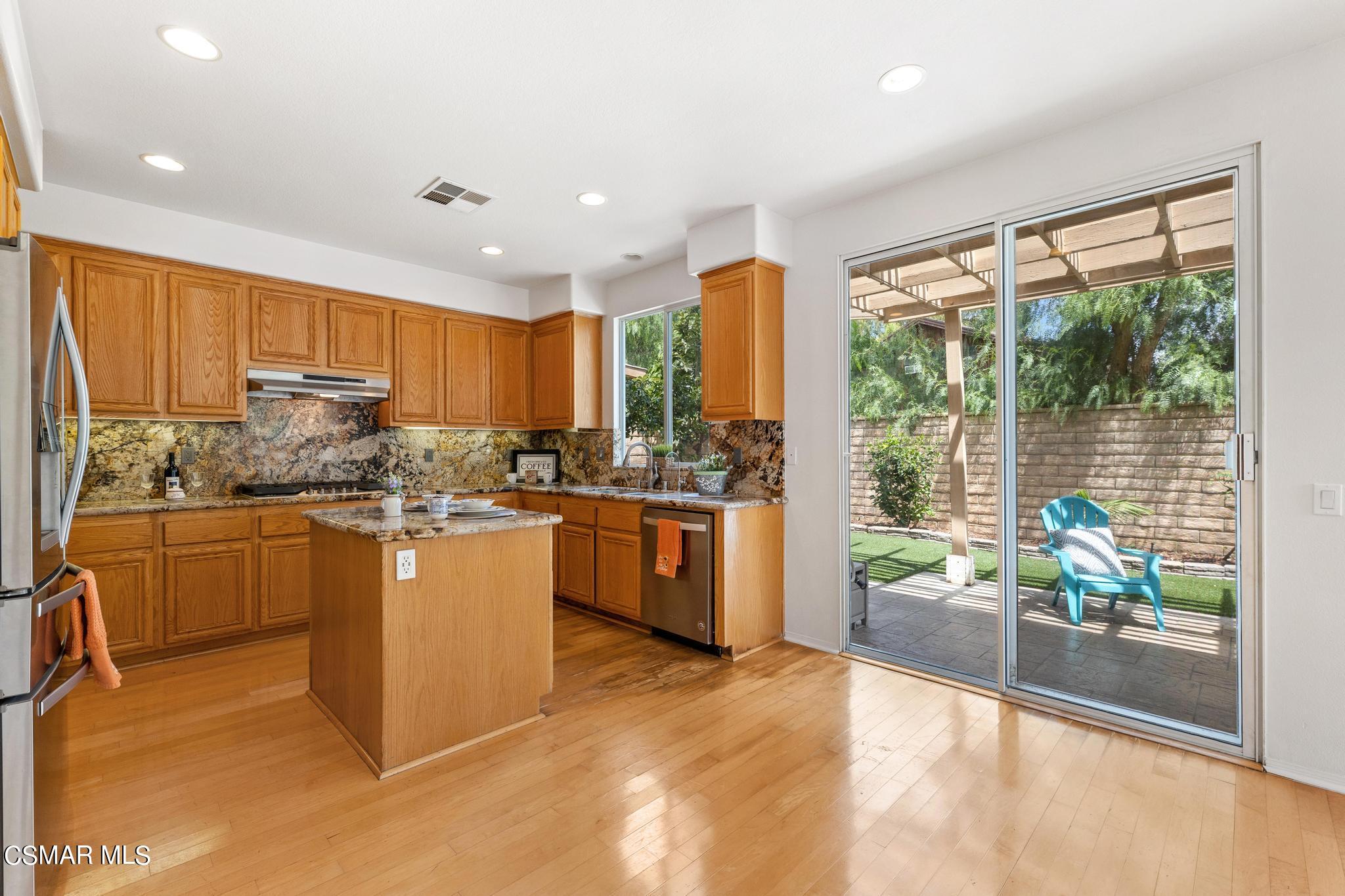 2442 Parade Avenue Simi Valley, CA 93063 - Photo 25 of 76 a kitchen with stainless steel appliances granite countertop a stove a sink and a refrigerator
