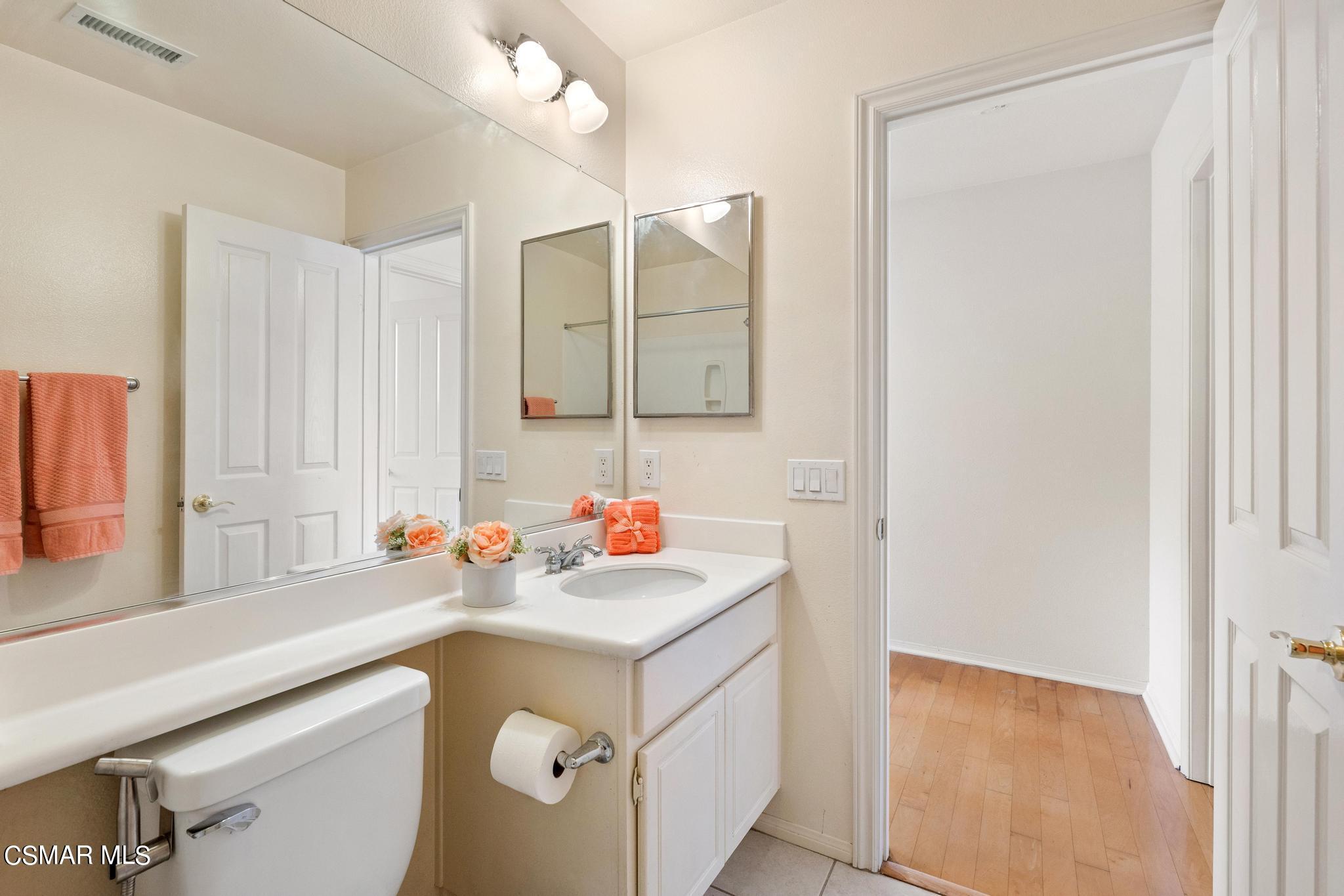 2442 Parade Avenue Simi Valley, CA 93063 - Photo 31 of 76 a bathroom with a sink vanity and a mirror