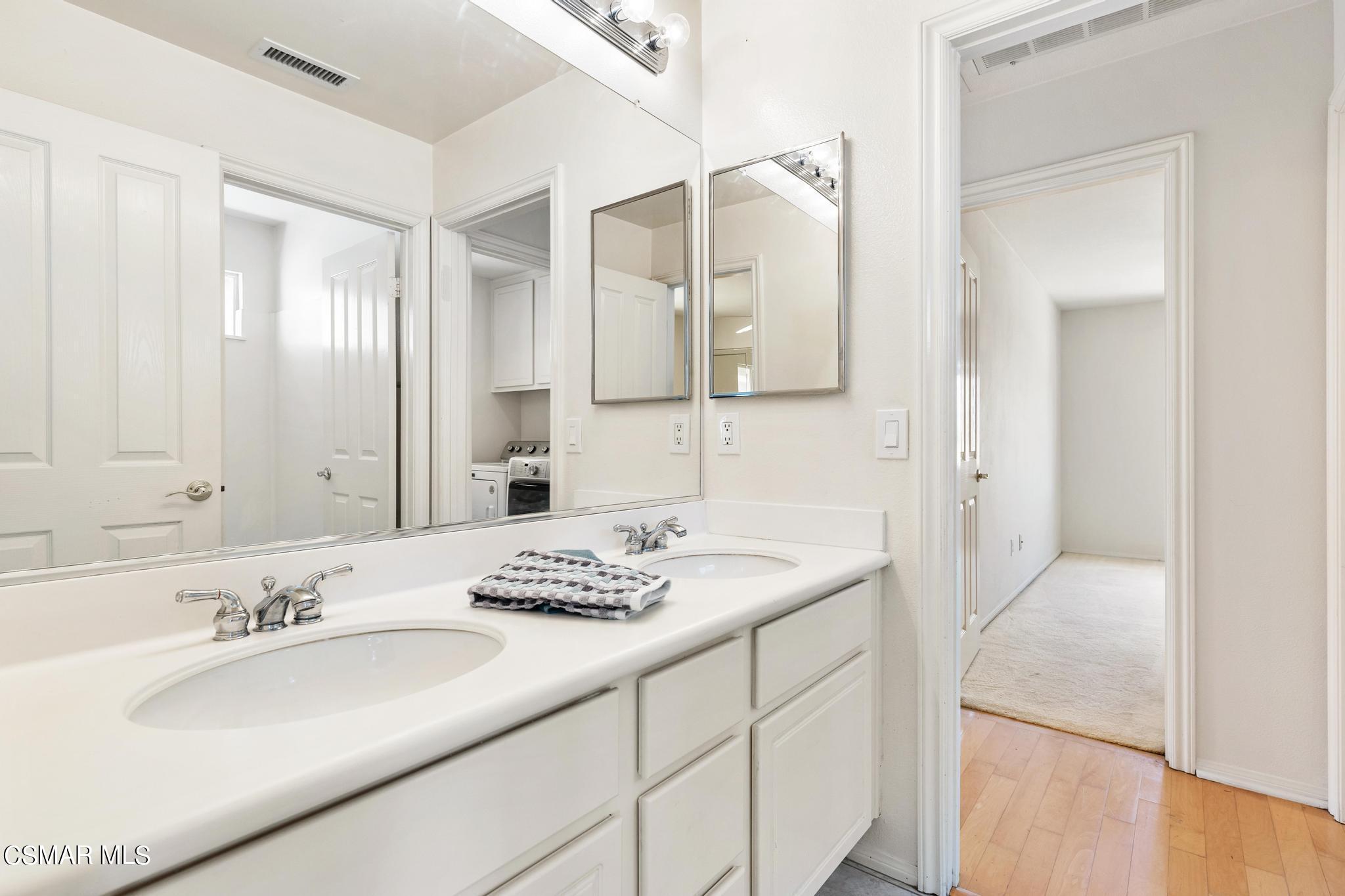 2442 Parade Avenue Simi Valley, CA 93063 - Photo 36 of 76 a bathroom with a granite countertop sink and a mirror
