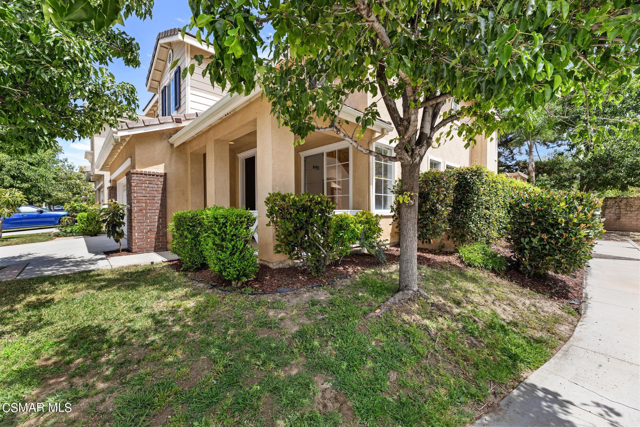 2442 Parade Avenue Simi Valley, CA 93063 - Photo 4 of 76 a front view of a house with a yard and trees