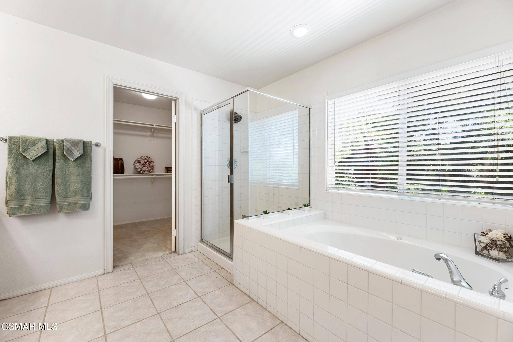 2442 Parade Avenue Simi Valley, CA 93063 - Photo 45 of 76 a spacious bathroom with a tub sink and mirror