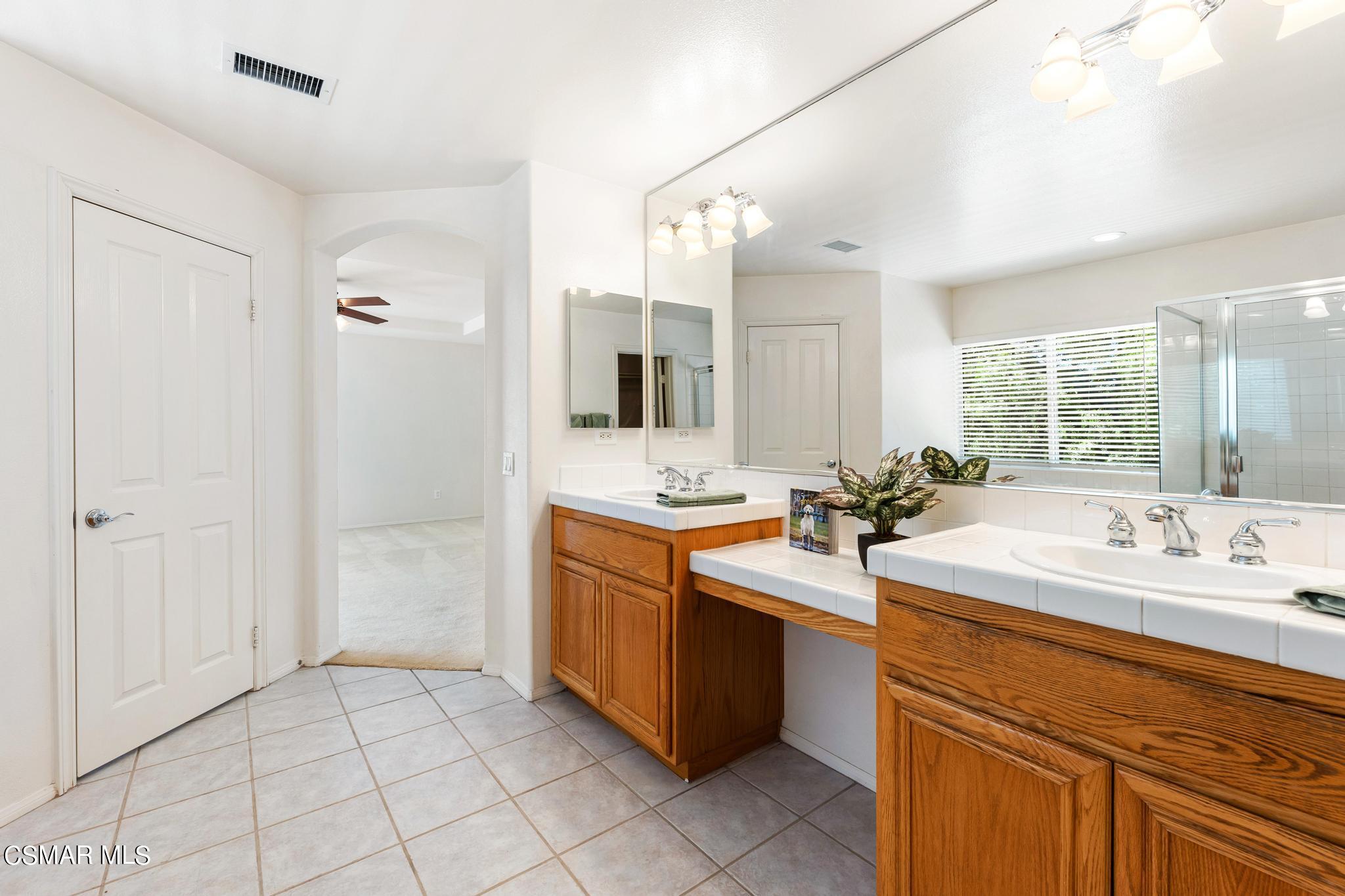 2442 Parade Avenue Simi Valley, CA 93063 - Photo 47 of 76 a spacious bathroom with a sink double vanity and a mirror