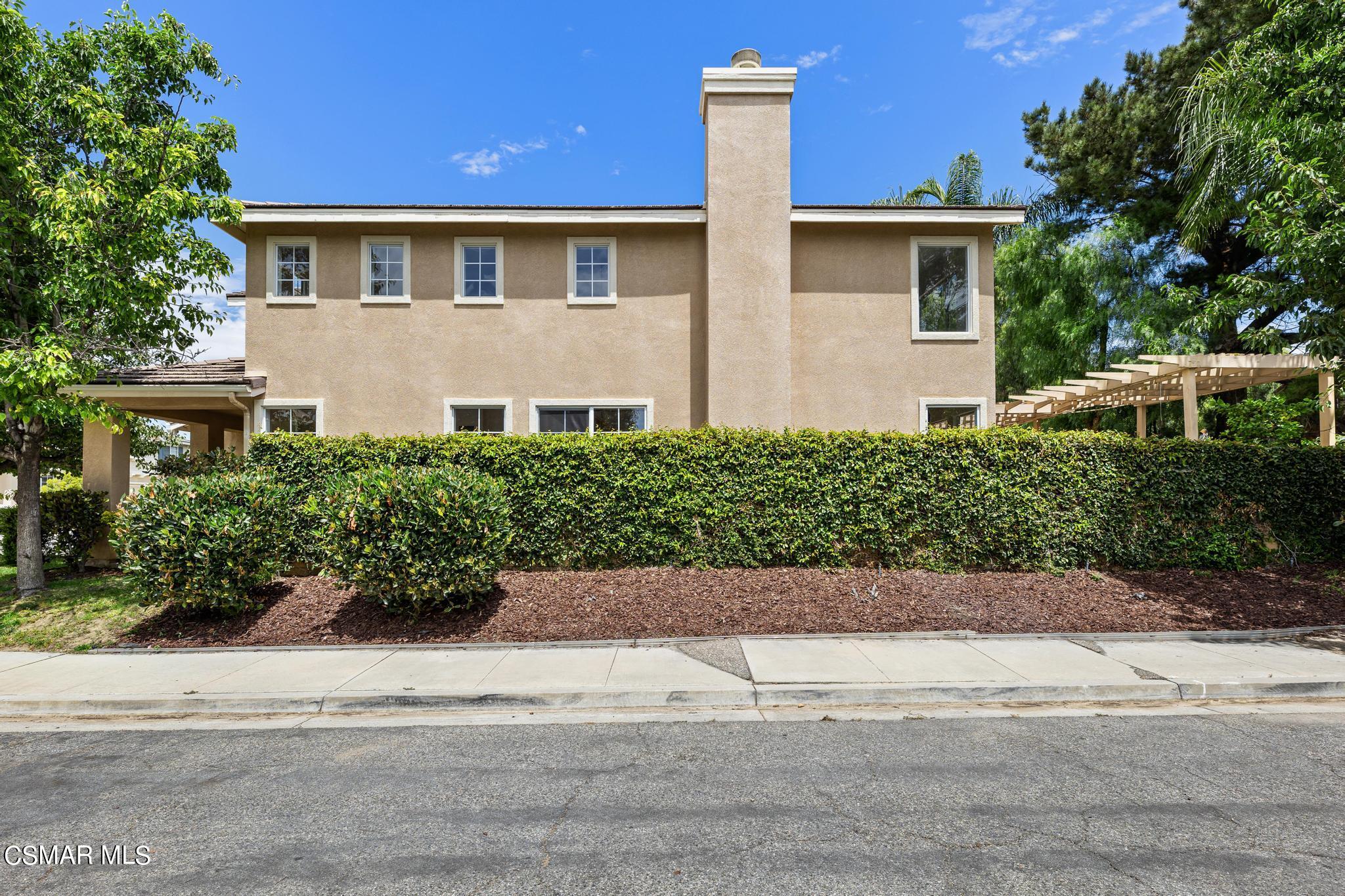 2442 Parade Avenue Simi Valley, CA 93063 - Photo 5 of 76 a front view of a house with a yard and a garage