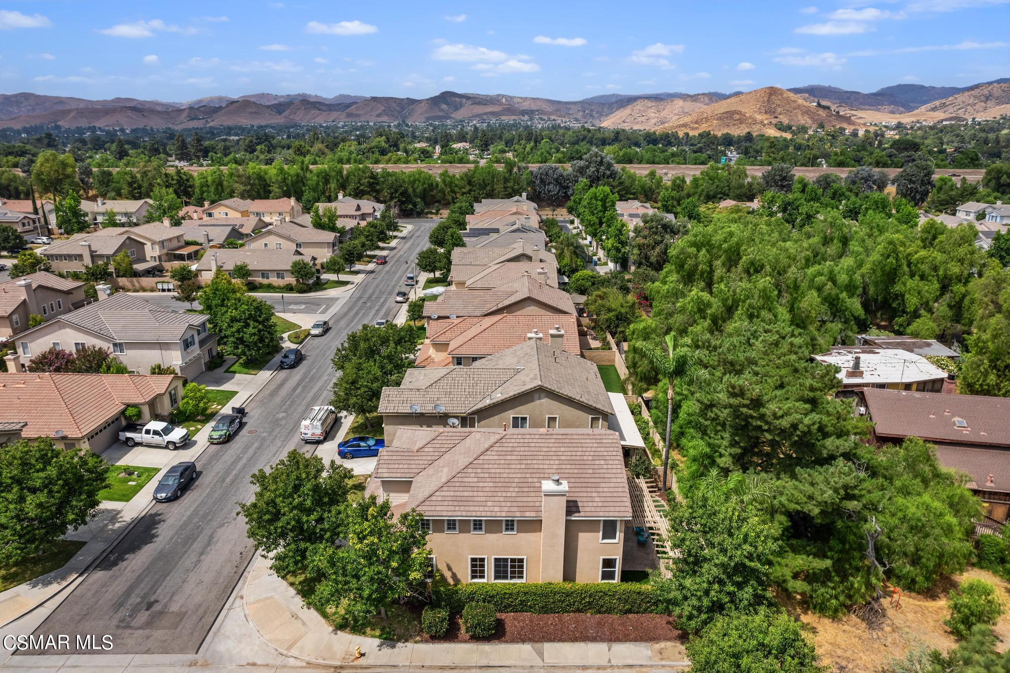 2442 Parade Avenue Simi Valley, CA 93063 - Photo 73 of 76 an aerial view of a city with lots of residential buildings and mountain view in back