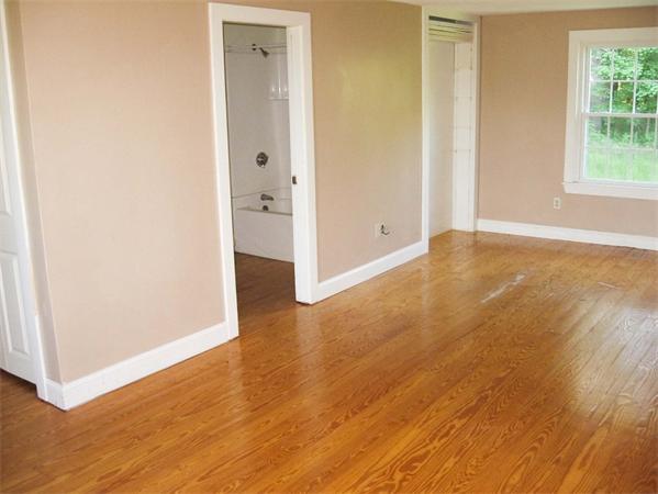 94 Main Street Rutland, MA 01543 - Photo 9 of 11 an empty room with wooden floor and windows