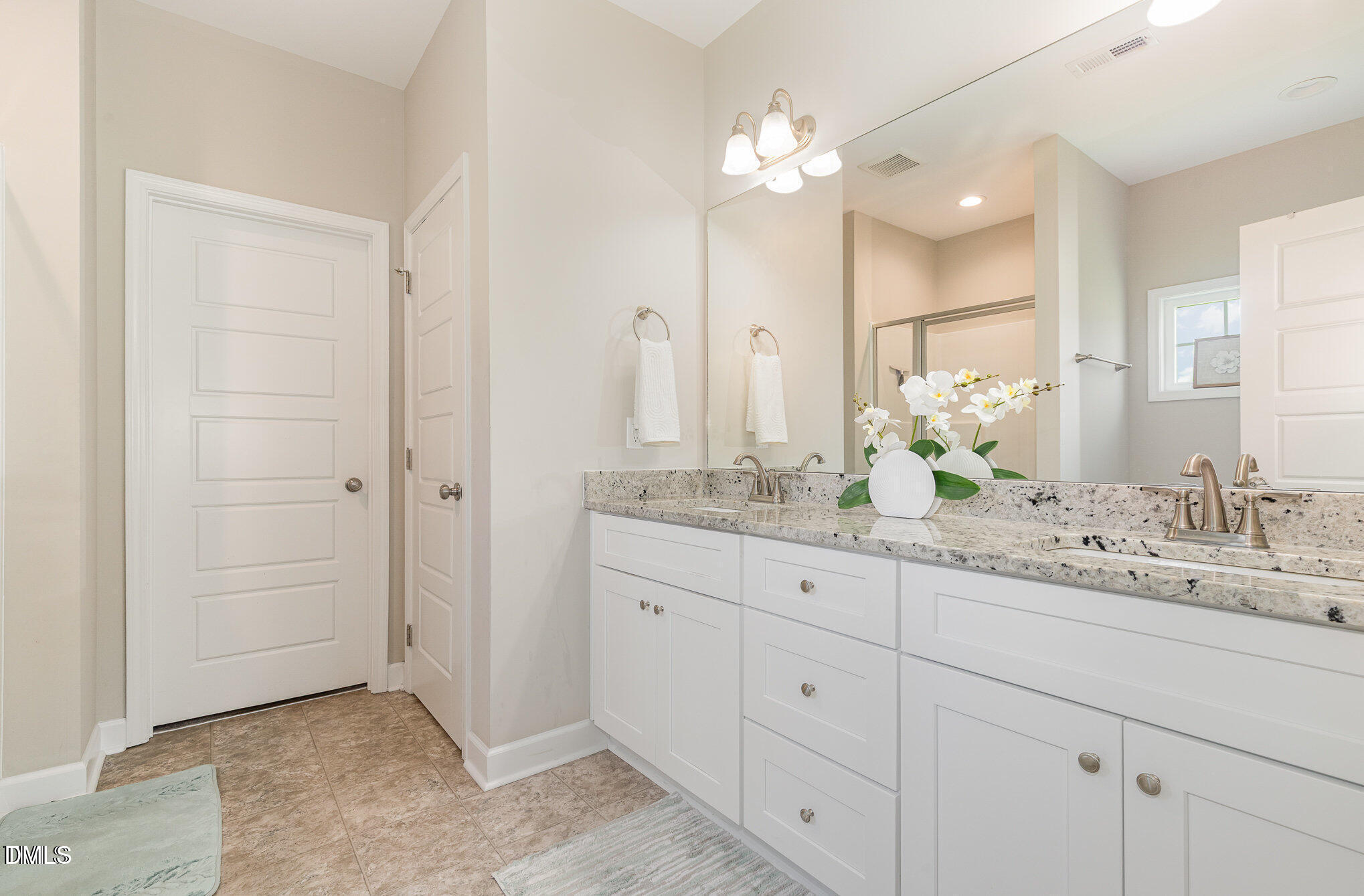 8662 Buckhorn Plantation Road Sims, NC 27880 - Photo 19 of 37 a bathroom with a double vanity sink and a mirror