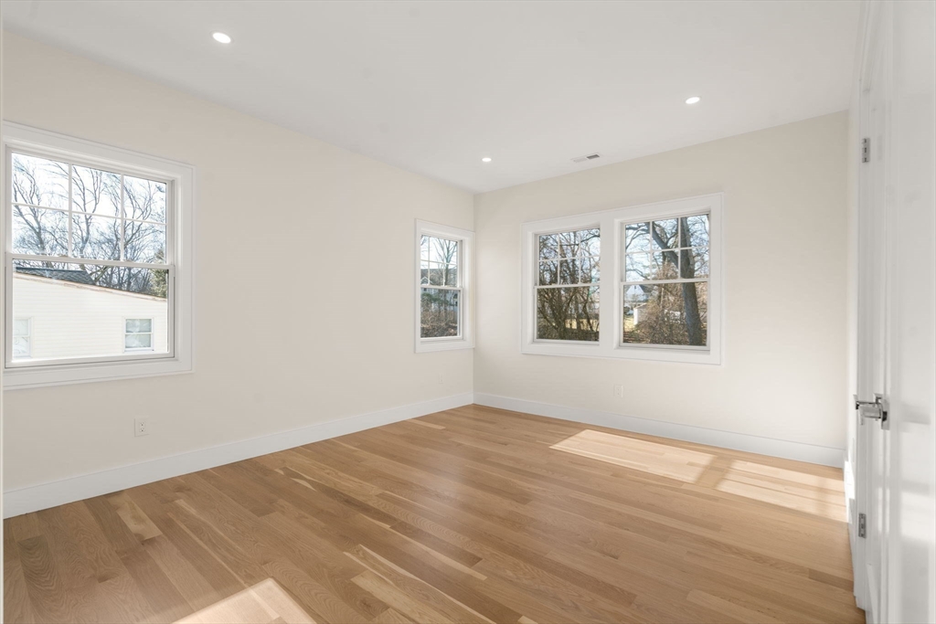 74 Gary Road Needham, MA 02494 - Photo 29 of 41 a view of an empty room with wooden floor and a window