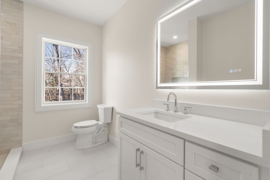 74 Gary Road Needham, MA 02494 - Photo 30 of 41 a bathroom with a sink a toilet and a window