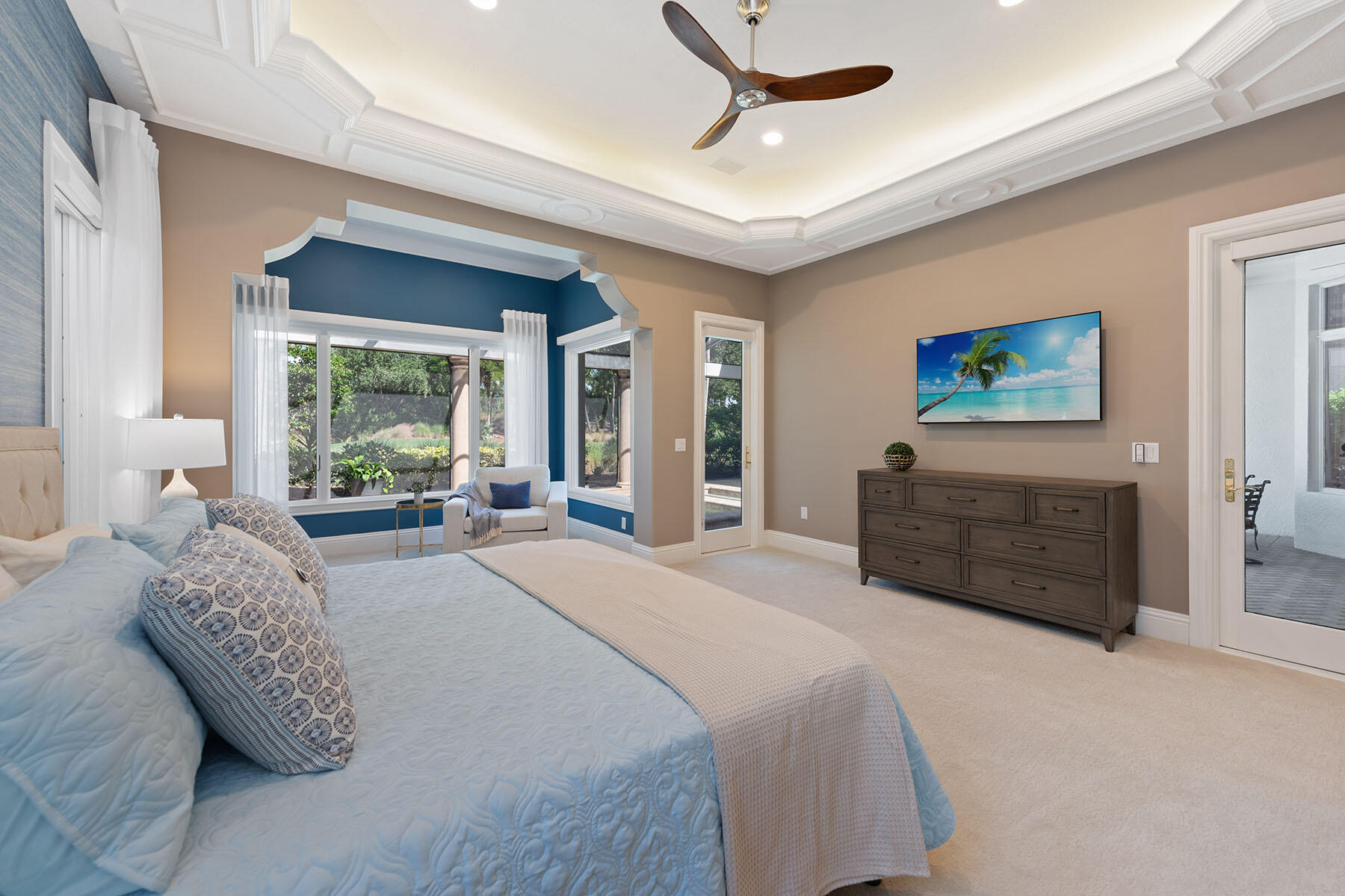8604 Majorca Lane Naples, FL 34114 - Photo 16 of 49 a spacious bedroom with a bed a dresser and a large window