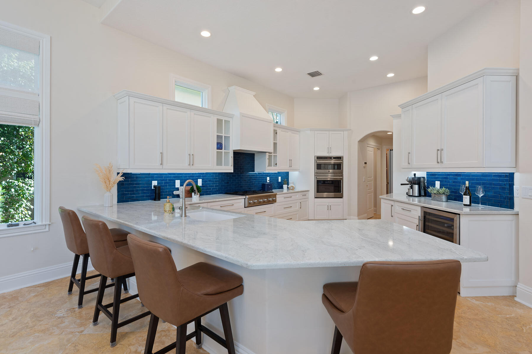 8604 Majorca Lane Naples, FL 34114 - Photo 6 of 49 a kitchen with stainless steel appliances kitchen island granite countertop a kitchen island and chairs in it
