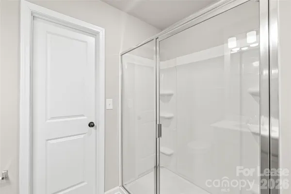 a bathroom with a glass shower door