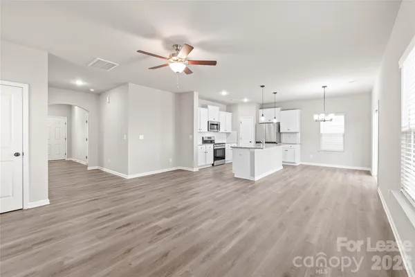 a view of a kitchen with wooden floor and a kitchen
