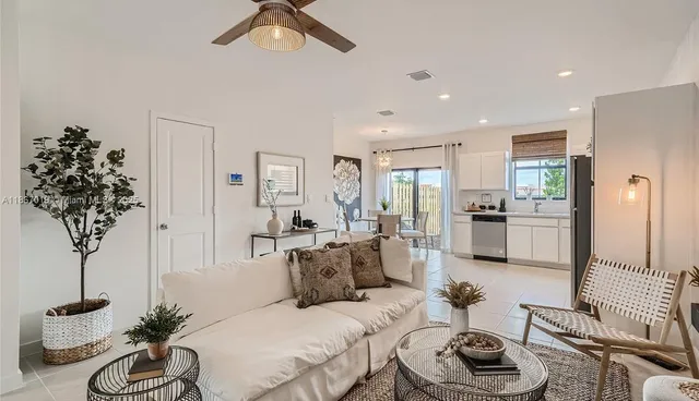 a living room with furniture potted plant and a chandelier