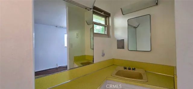 a bathroom with a tub sink and mirror