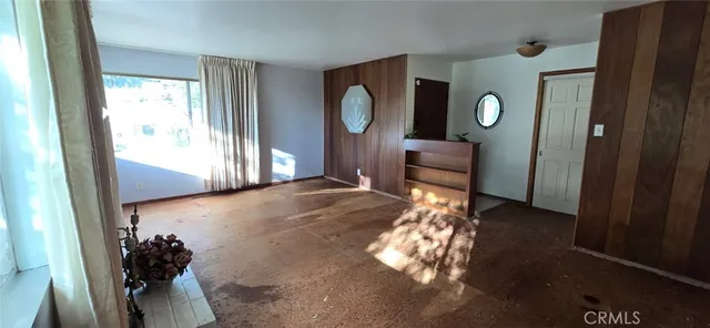 a living room with couches mirror and a table with wooden floor