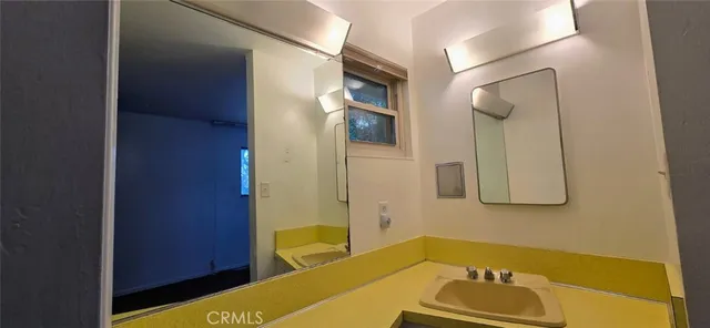 a bathroom with a tub sink and mirror