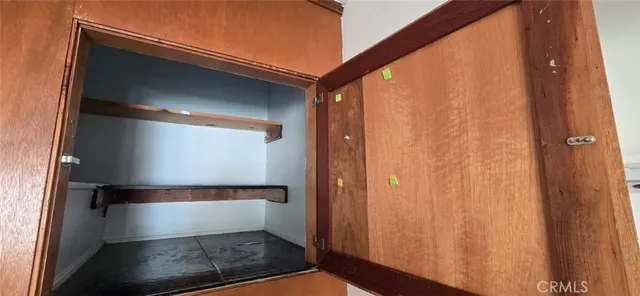 a bathroom with a granite countertop toilet sink and mirror