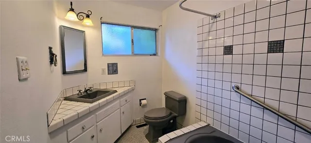 a view of a livingroom with a window and a ceiling fan