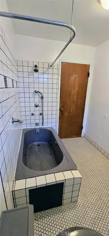 an empty room with fan walk in closet with window