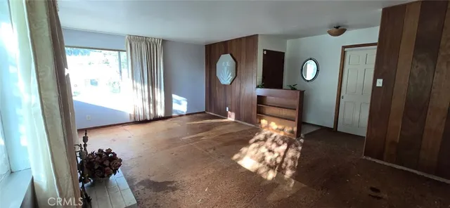 a view of a livingroom with furniture mirror and window
