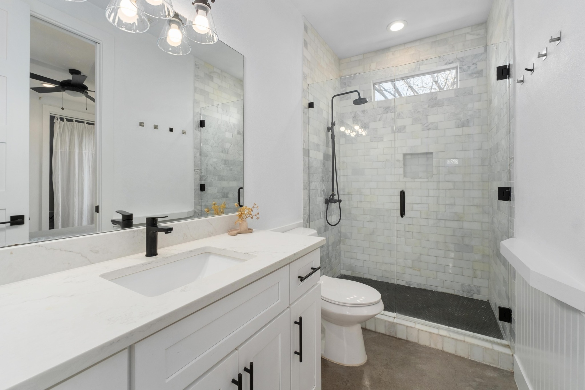 2014 East 9th Street, Unit 2 Austin, TX 78702 - Photo 16 of 23 Bathroom features a spacious vanity, a walk-in shower with shower niche and frameless shower door, recessed lighting, and concrete flooring.