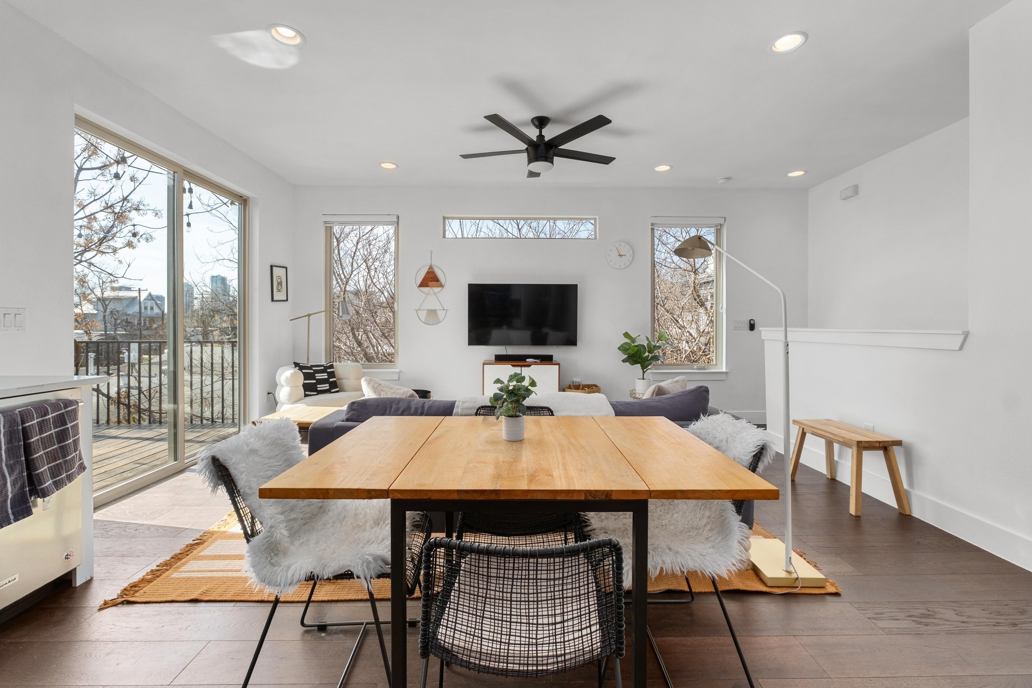 2014 East 9th Street, Unit 2 Austin, TX 78702 - Photo 4 of 23 The kitchen flows seamlessly into the living room, highlighted by wood floors, modern finishes, recessed lighting, an updated ceiling fan, and abundant natural light. A conveniently located half bath offers easy access for guests.