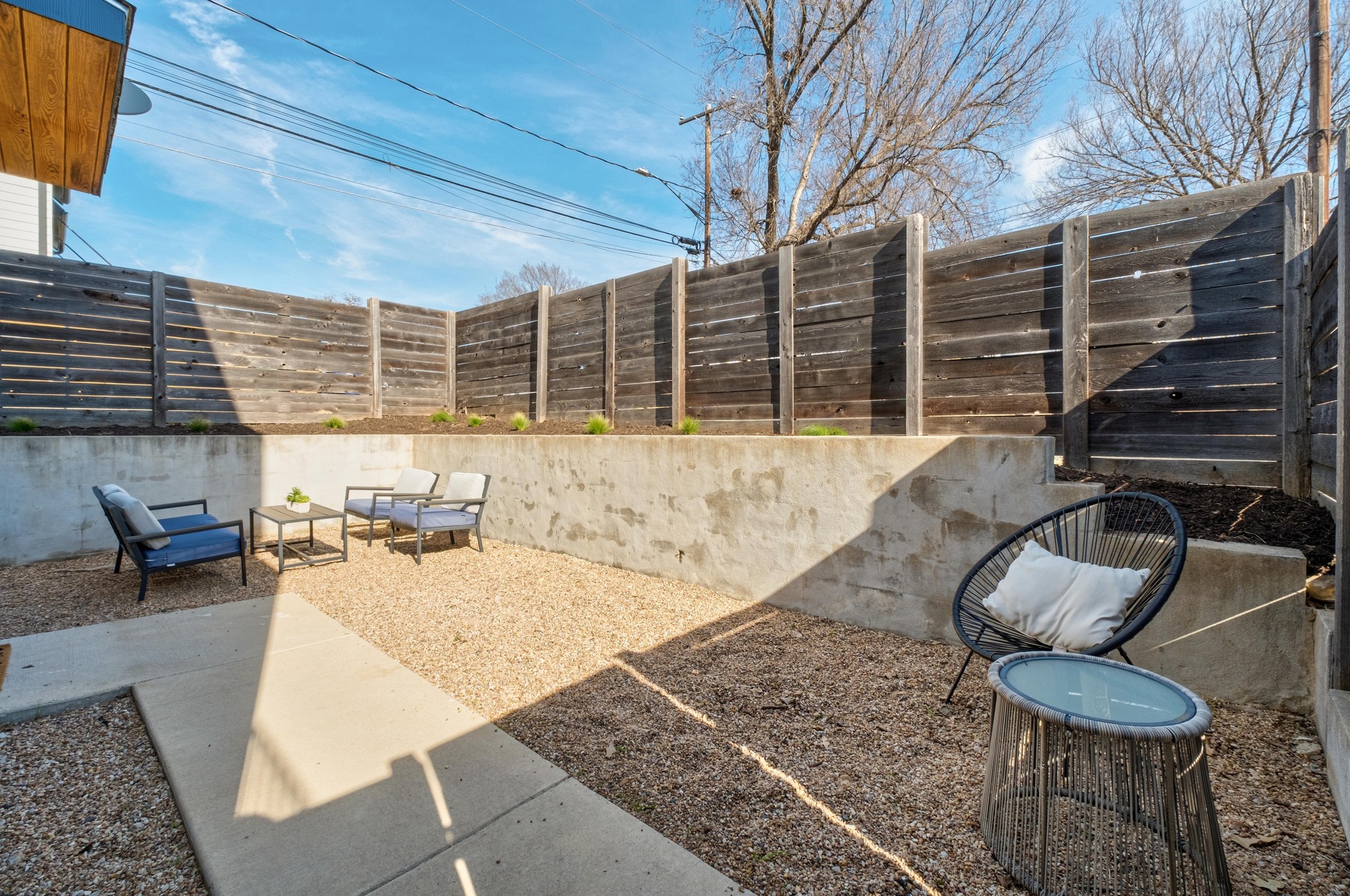 2014 East 9th Street, Unit 2 Austin, TX 78702 - Photo 7 of 23 Fenced yard with a patio and outdoor lounge area, thoughtfully xeriscaped for easy, low-maintenance living.