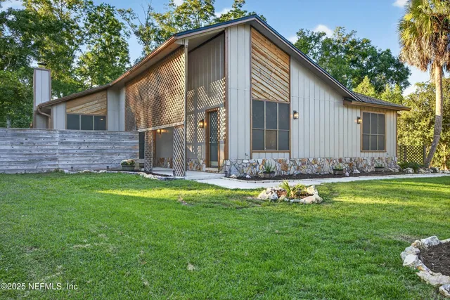 a front view of house with yard and green space