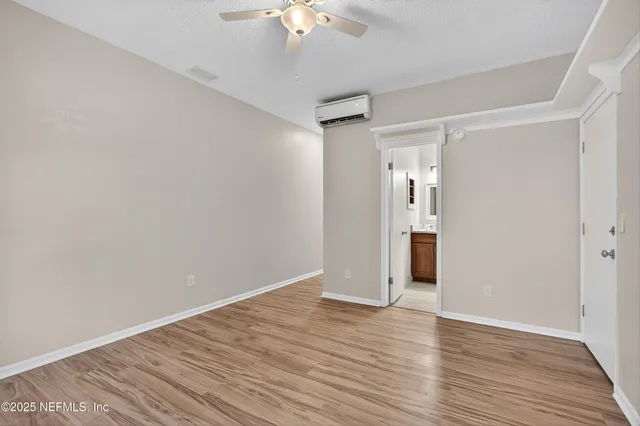 a bathroom with a granite countertop sink toilet and a mirror
