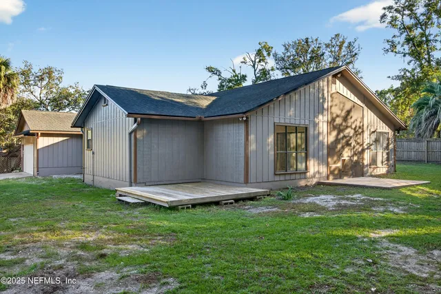 a view of a house with a wooden fence