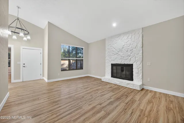 wooden floor fireplace and natural light in room