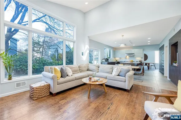 a bathroom with a toilet a sink a mirror and a tub